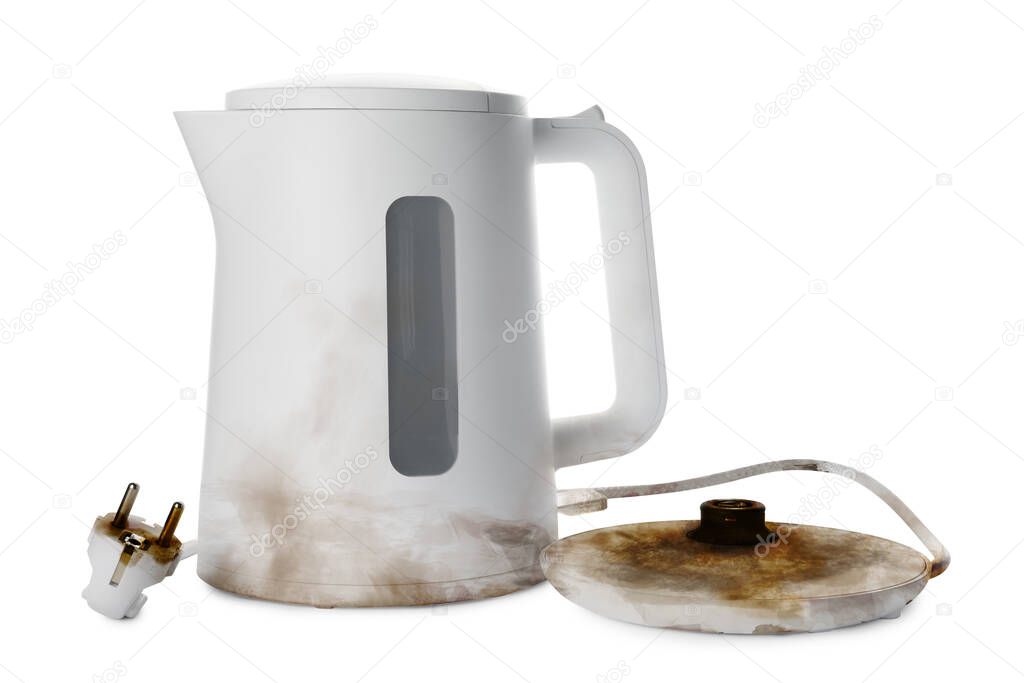 Burnt electric kettle with base and plug on white background
