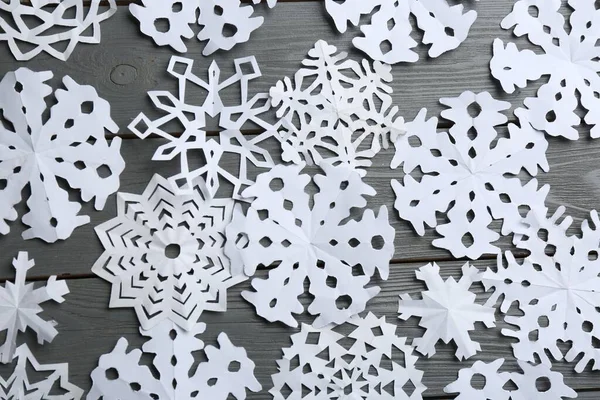 Many Paper Snowflakes Grey Wooden Background Flat Lay — Stock Fotó
