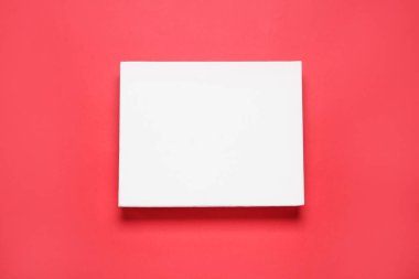 Blank canvas on red background, top view. Space for design