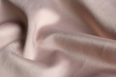 Arkaplan olarak narin pembe kumaş dokusu, yakın plan