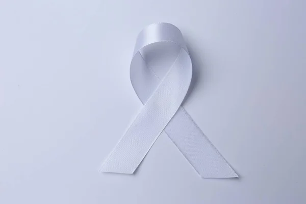 White Awareness Ribbon White Background Top View — Stok fotoğraf