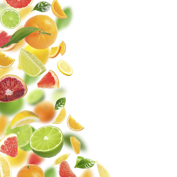 Fresh juicy citrus fruits and green leaves falling on white background