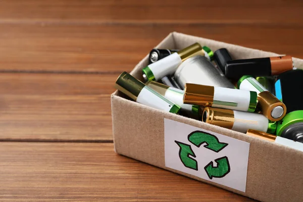 Used Batteries Cardboard Box Recycling Symbol Wooden Table Closeup Space — Fotografia de Stock