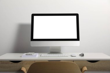 Workplace with modern computer and smartphone on white table. Mockup for design