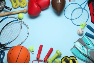 Set of different sports equipment on light blue background, flat lay. Space for text