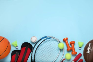 Set of different sports equipment on light blue background, flat lay. Space for text