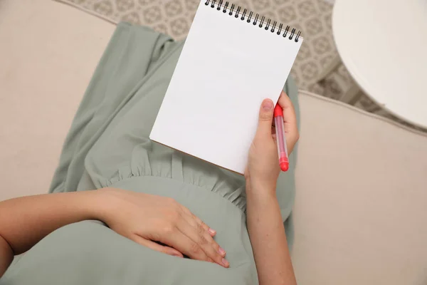 Pregnant Woman Notebook Marker Choosing Name Baby Sofa Top View — Stockfoto