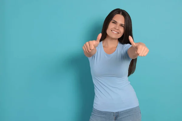 Young Woman Showing Thumbs Light Blue Background Space Text — Fotografia de Stock