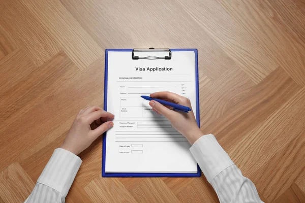 Woman Filling Visa Application Form Immigration Table Top View — Foto Stock