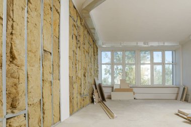 Wall with metal studs and insulation material indoors. Repair and maintenance