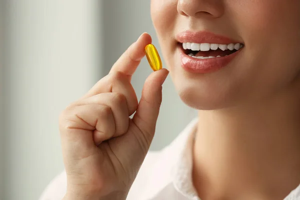 Young Woman Taking Dietary Supplement Pill Blurred Background Closeup — Stok fotoğraf