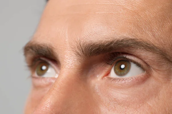 Man Beautiful Hazel Eyes Grey Background Closeup —  Fotos de Stock