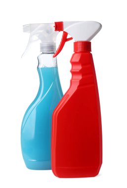 Spray bottles with detergents on white background. Cleaning supplies
