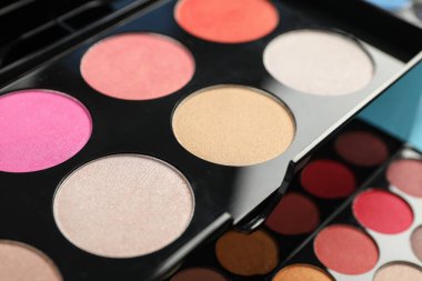 Beautiful palette of colorful eyeshadows as background, closeup