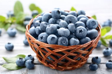 Tasty fresh blueberries on wooden table, closeup