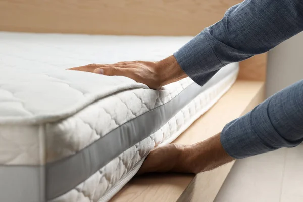 Man Touching Soft White Mattress Indoors Closeup — Stock Fotó