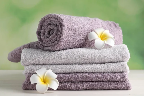 Soft Folded Towels Plumeria Flowers White Wooden Table — 스톡 사진