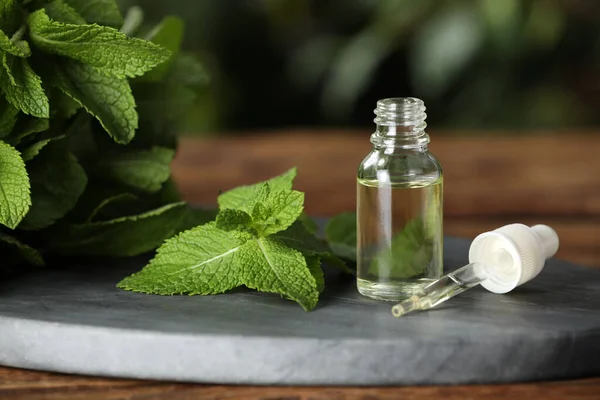Bottle Mint Essential Oil Pipette Green Leaves Wooden Table Closeup — Stockfoto