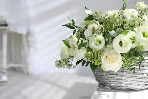 Basket with beautiful wedding flowers on window sill indoors, closeup