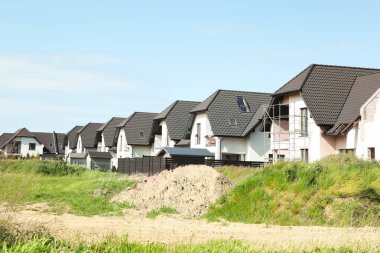 Many houses with grey roofs outdoors on sunny day