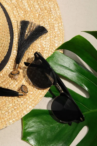 Stylish Sunglasses Tropical Leaf Earrings Straw Hat Sand Flat Lay — Photo