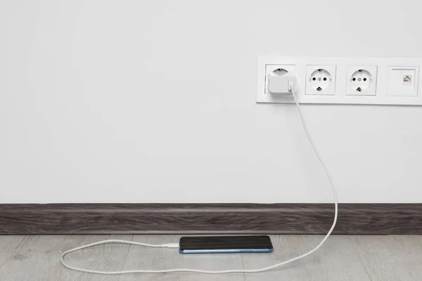 Modern Smartphone Charging Electric Socket Indoors Space Text — Fotografia de Stock