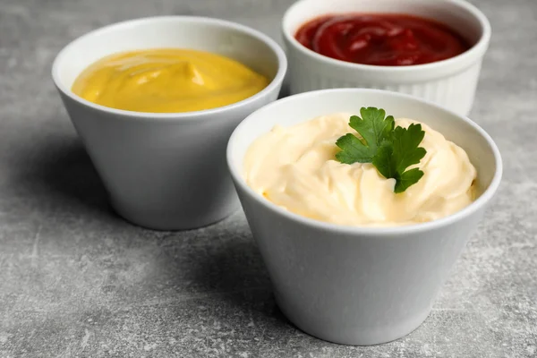 Bowls Mustard Ketchup Mayonnaise Light Grey Table Closeup — Stockfoto