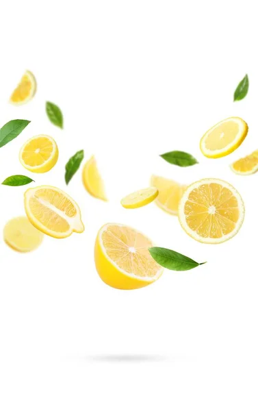 Fresh Ripe Lemons Green Leaves Falling White Background — Fotografia de Stock