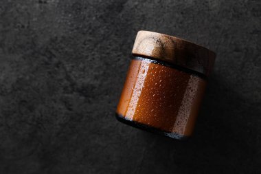 Jar of cosmetic product on grey background, top view. Space for text
