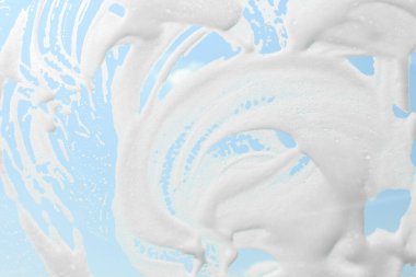 Glass covered with suds as background, view from inside