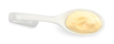 Mayonnaise in ceramic serving spoon isolated on white, top view