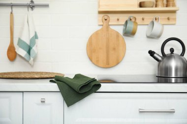 Clean towel on white countertop in kitchen
