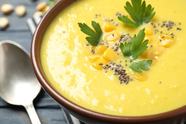 Delicious creamy corn soup on table, closeup