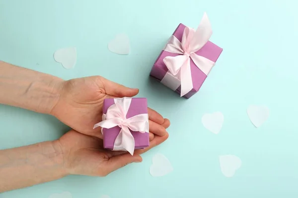 Woman Holding Gift Box Turquoise Background Top View Valentine Day — 图库照片