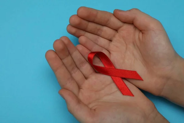 Little Girl Holding Red Ribbon Blue Background Closeup Aids Disease — Photo