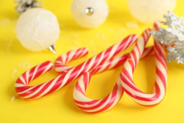 Sweet Christmas Candy Canes Yellow Background Closeup — Foto de Stock