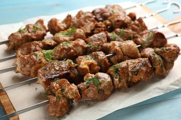 Metal Skewers Delicious Meat Served Light Blue Wooden Table Closeup — Foto de Stock