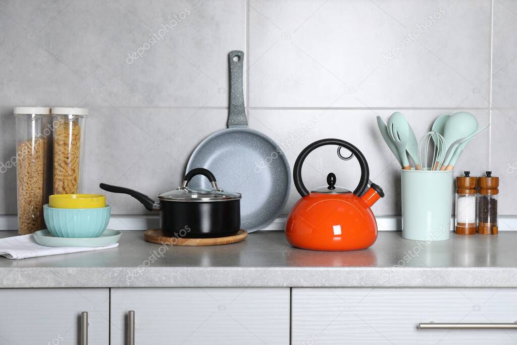 Cooking utensils and other kitchenware on grey countertop
