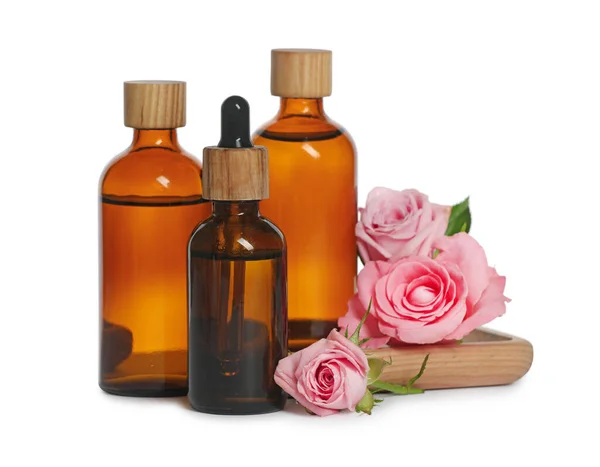 Bottles Essential Rose Oil Flowers White Background — Zdjęcie stockowe