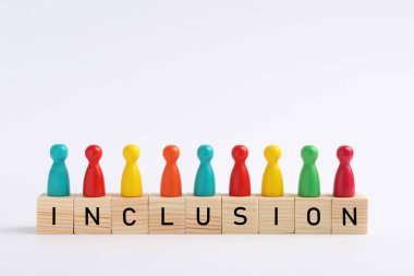Colorful pawns and cubes with word Inclusion on white background