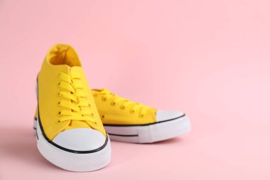 Pair of stylish sneakers on pink background, space for text
