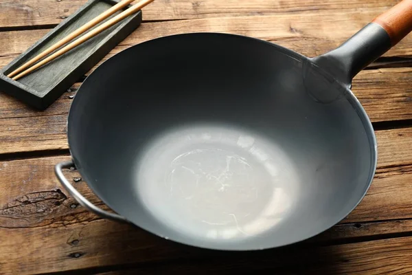 Empty Iron Wok Chopsticks Wooden Table Closeup — Stock fotografie