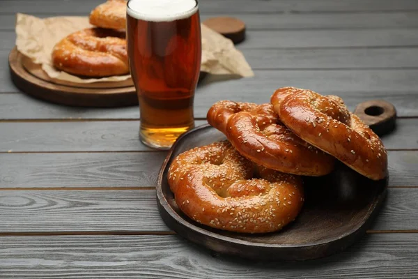 Tasty Freshly Baked Pretzels Glass Beer Grey Wooden Table Space — Stock Photo, Image