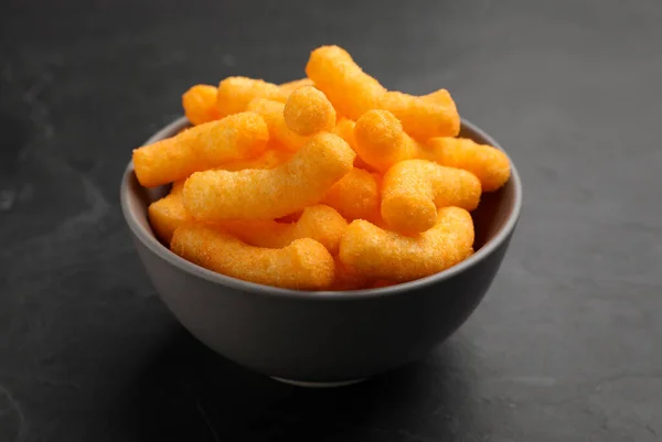Many Tasty Cheesy Corn Puffs Bowl Black Table Closeup View — Stock Fotó