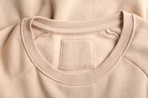 Blank Clothing Label Beige Sweater Top View — Foto Stock