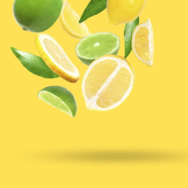 Fresh Juicy Citrus Fruits Green Leaves Falling Yellow Background — Fotografia de Stock