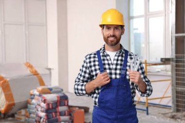 Portrait of professional builder in uniform indoors