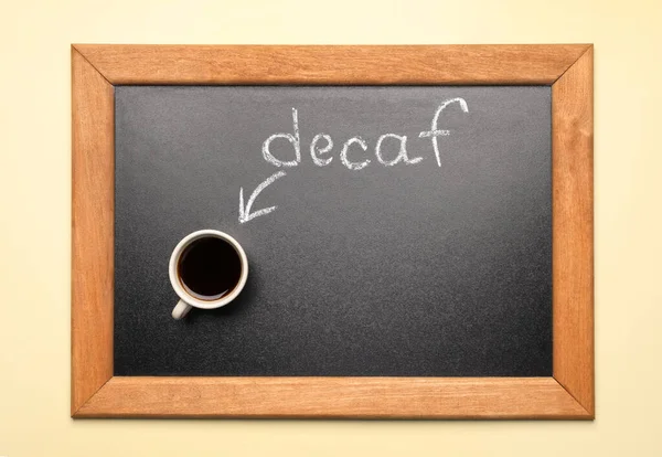 Chalkboard Word Decaf Cup Coffee Beige Background Top View —  Fotos de Stock