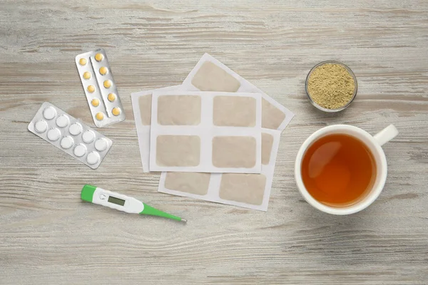 Flat lay composition with mustard plasters on wooden table