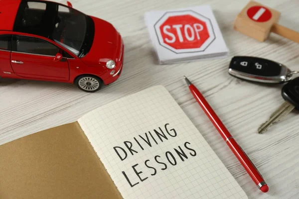 Composition Workbook Driving Lessons Toy Car White Wooden Background Passing — Foto Stock